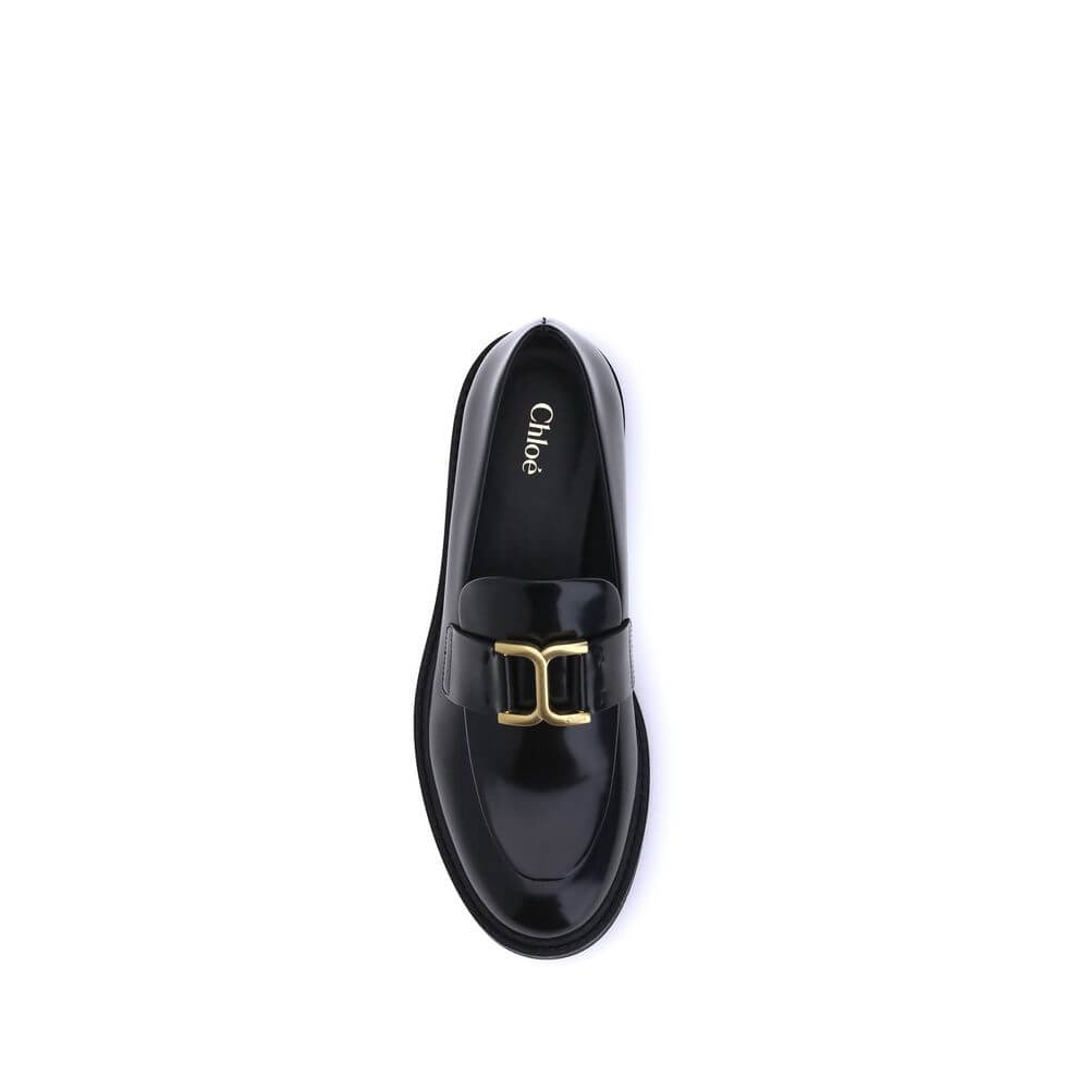 Black Calf Leather Bos Taurus Slip-On LoafersMarcie Loafers by Chloé combine classic elegance with refined details. Crafted with a glossy finish, they are embellished with refined gold-tone detailing and embossed stitching that enhance their craftsmanship