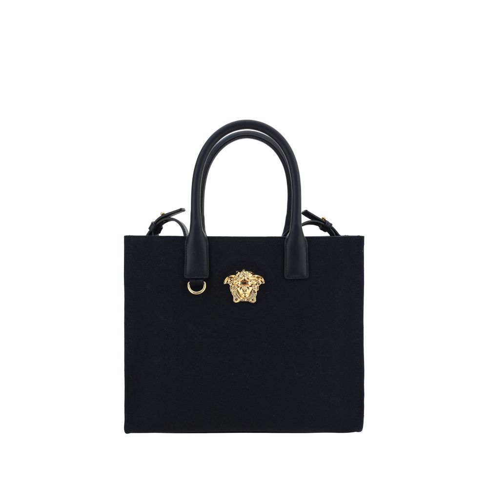 Black Cotton Shoulder BagCotton Shoulder Bag by Versace, rigid leather top handles, removable flat shoulder strap, top button closure, single interior compartment, iconic brand monogram embossed on front, leather feet at base, iconic Medusa embossed appli