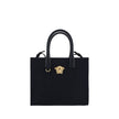 Black Cotton Shoulder BagCotton Shoulder Bag by Versace, rigid leather top handles, removable flat shoulder strap, top button closure, single interior compartment, iconic brand monogram embossed on front, leather feet at base, iconic Medusa embossed appli