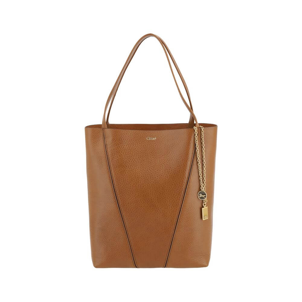 Brown Calf Leather Bos Taurus Shoulder BagLeather Spin Shoulder Bag by Chloé is a refined and modern accessory featuring a sleek grained leather design. The two flat top handles offer a comfortable and practical grip, while the brand’s iconic monogram, pr