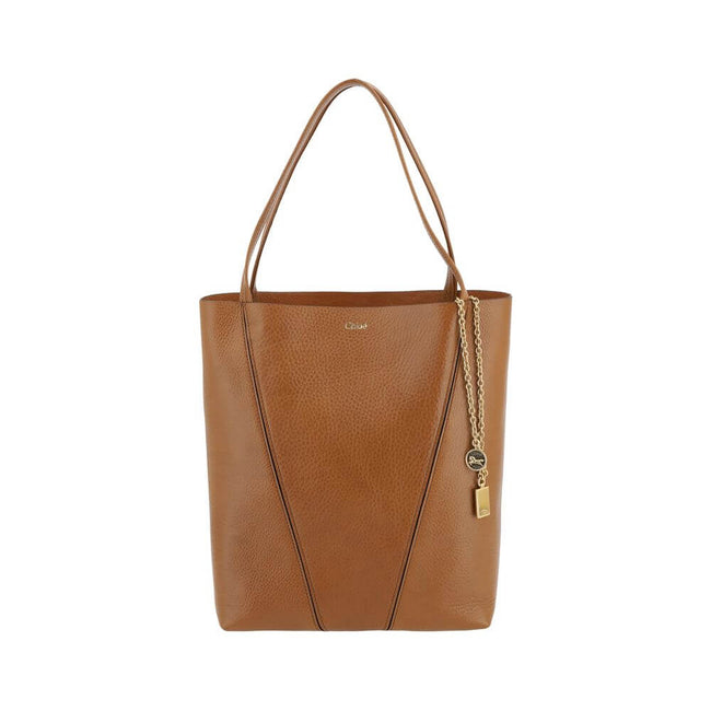 Brown Calf Leather Bos Taurus Shoulder BagLeather Spin Shoulder Bag by Chloé is a refined and modern accessory featuring a sleek grained leather design. The two flat top handles offer a comfortable and practical grip, while the brand’s iconic monogram, pr