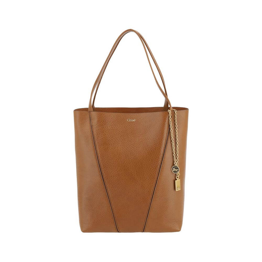 Brown Calf Leather Bos Taurus Shoulder BagLeather Spin Shoulder Bag by Chloé is a refined and modern accessory featuring a sleek grained leather design. The two flat top handles offer a comfortable and practical grip, while the brand’s iconic monogram, pr