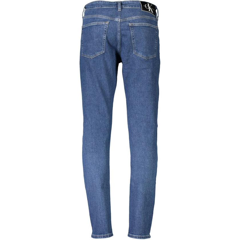 Blue Cotton Men JeansElevate your wardrobe with these quintessential Calvin Klein slim taper jeans, crafted for the modern trendsetter. These jeans flaunt a classic five-pocket construction combined with a sleek button and zip closure. The subtle embroide