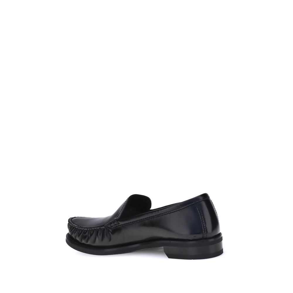 Black Calf Leather Bos Taurus Slip-On LoafersPrada’s brushed leather Loafers reinterpret a classic with a tapered, lightweight silhouette enhanced by the elegant finish of brushed leather. The refined handcrafted construction emphasizes the minimalist cha