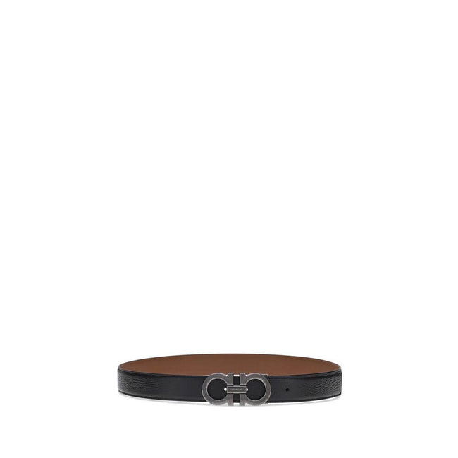 Black Calf Leather Bos Taurus Regular BeltFerragamo’s Gancini reversible Belt is an iconic accessory, featuring its distinctive Gancini buckle in a ruthenium finish. The buckle is embellished with fine vertical knurling, adding a touch of elegance. This m