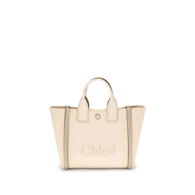 Beige Cotton Shoulder BagChloé’s Carry Tote Bag is a stylish, multifunctional accessory made of cotton with contrasting leather details that accentuate its sophisticated appeal. Magnetic buttons on the side panels allow you to adjust the width of the bag