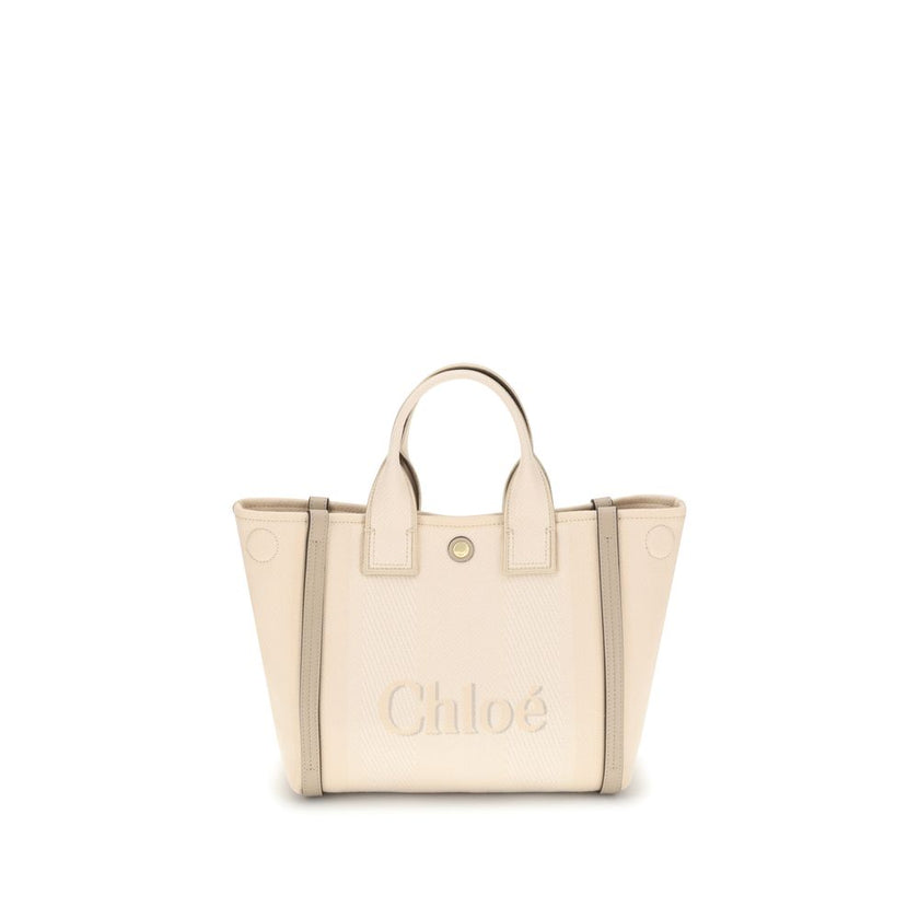 Beige Cotton Shoulder BagChloé’s Carry Tote Bag is a stylish, multifunctional accessory made of cotton with contrasting leather details that accentuate its sophisticated appeal. Magnetic buttons on the side panels allow you to adjust the width of the bag