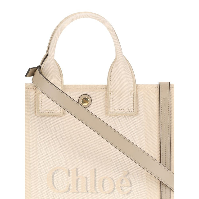 Beige Cotton Shoulder BagChloé’s Carry Tote Bag is a stylish, multifunctional accessory made of cotton with contrasting leather details that accentuate its sophisticated appeal. Magnetic buttons on the side panels allow you to adjust the width of the bag
