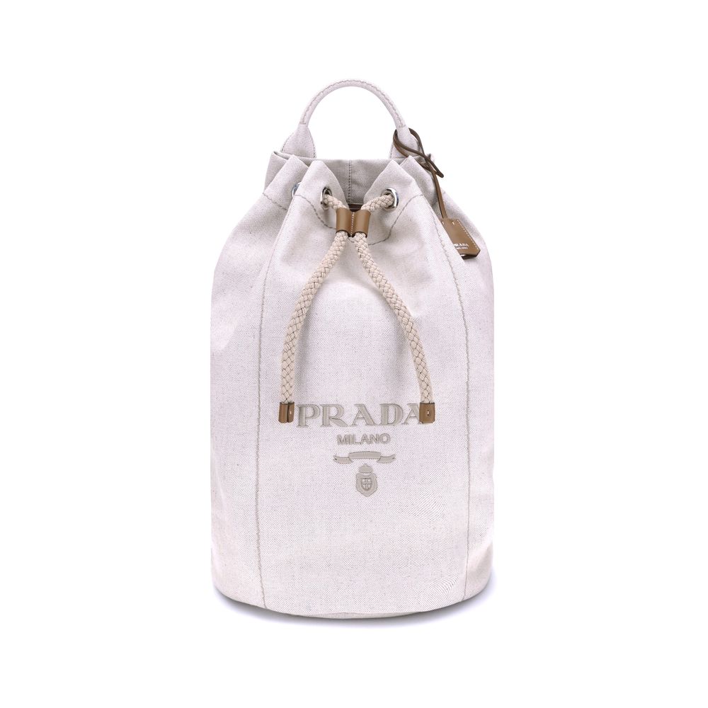 White Cotton Backet BagPrada’s Linen Bucket Bag features a lightweight design with a sporty character. It features a linen handle and an adjustable shoulder strap enhanced with leather details and the iconic tone-on-tone embroidered logo that gives the ac