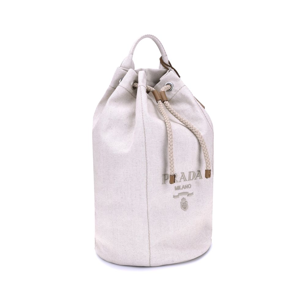 White Cotton Backet BagPrada’s Linen Bucket Bag features a lightweight design with a sporty character. It features a linen handle and an adjustable shoulder strap enhanced with leather details and the iconic tone-on-tone embroidered logo that gives the ac