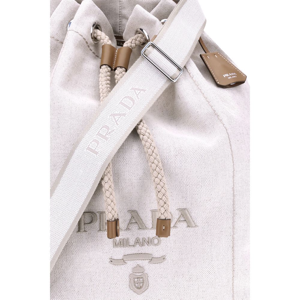 White Cotton Backet BagPrada’s Linen Bucket Bag features a lightweight design with a sporty character. It features a linen handle and an adjustable shoulder strap enhanced with leather details and the iconic tone-on-tone embroidered logo that gives the ac