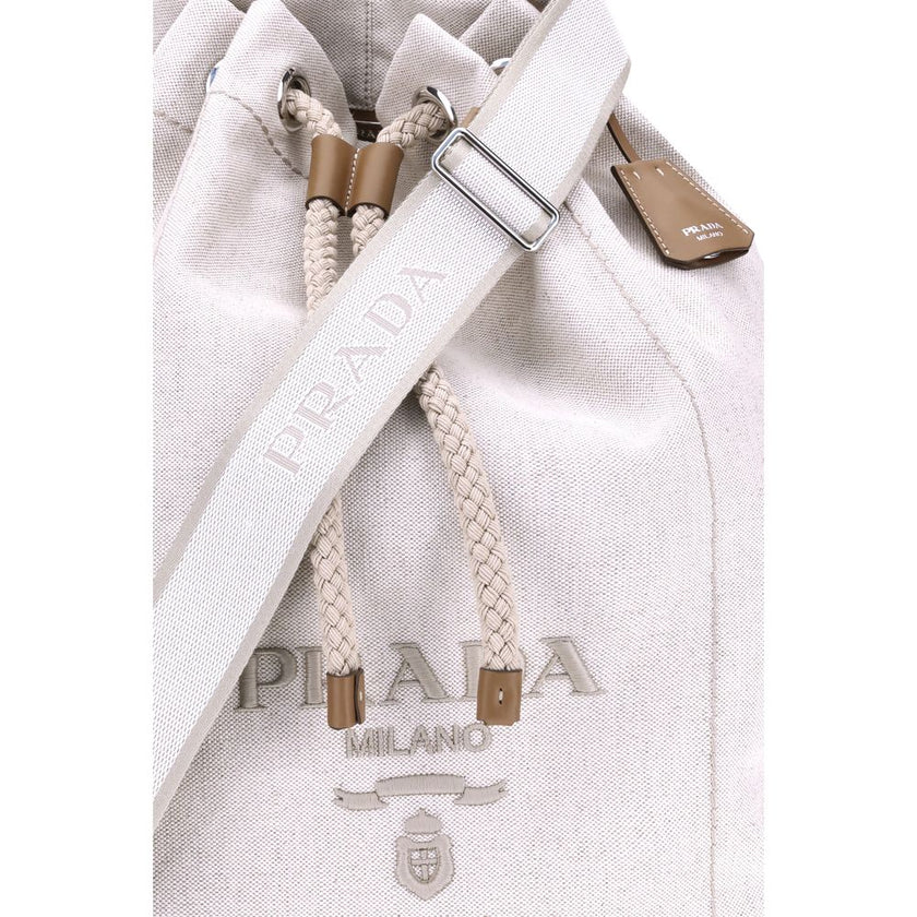 White Cotton Backet BagPrada’s Linen Bucket Bag features a lightweight design with a sporty character. It features a linen handle and an adjustable shoulder strap enhanced with leather details and the iconic tone-on-tone embroidered logo that gives the ac