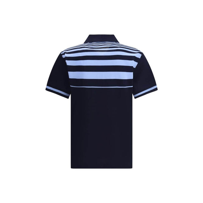 Blue Cotton Polo ShirtThe Cotton Polo Shirt by Ferragamo is a perfect balance of elegance and casual style. Featuring a classic collar and front buttons, it features a welt pocket embellished with the brand’s contrasting signature. Practical side slits an