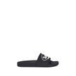 Black Rubber Flat SandalsThe Sholl X Balenciaga Rubber Slippers feature a flat sole and the iconic contrasting logo on the front band, combining comfort and distinctive design in a casual, contemporary style. Season: AW25 Composition: 100% Rubber MADE IN
