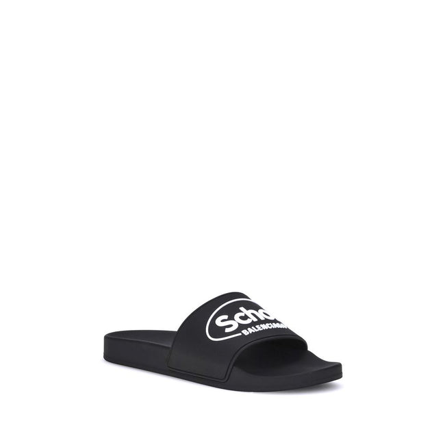Black Rubber Flat SandalsThe Sholl X Balenciaga Rubber Slippers feature a flat sole and the iconic contrasting logo on the front band, combining comfort and distinctive design in a casual, contemporary style. Season: AW25 Composition: 100% Rubber MADE IN