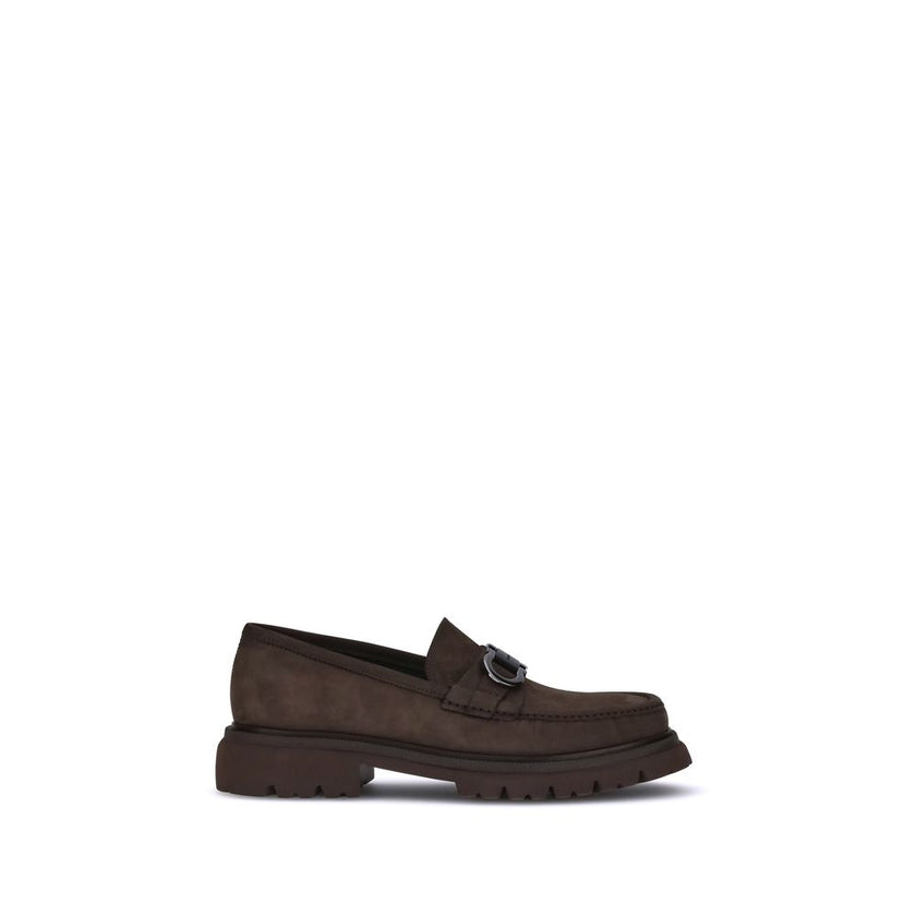 Brown Calf Leather Bos Taurus Slip-On LoafersFerragamo’s Gancini Loafers combine traditional craftsmanship and a contemporary spirit in a sophisticated, bold design. Made of soft suede, they are distinguished by the refined Gancini detail on the front, th