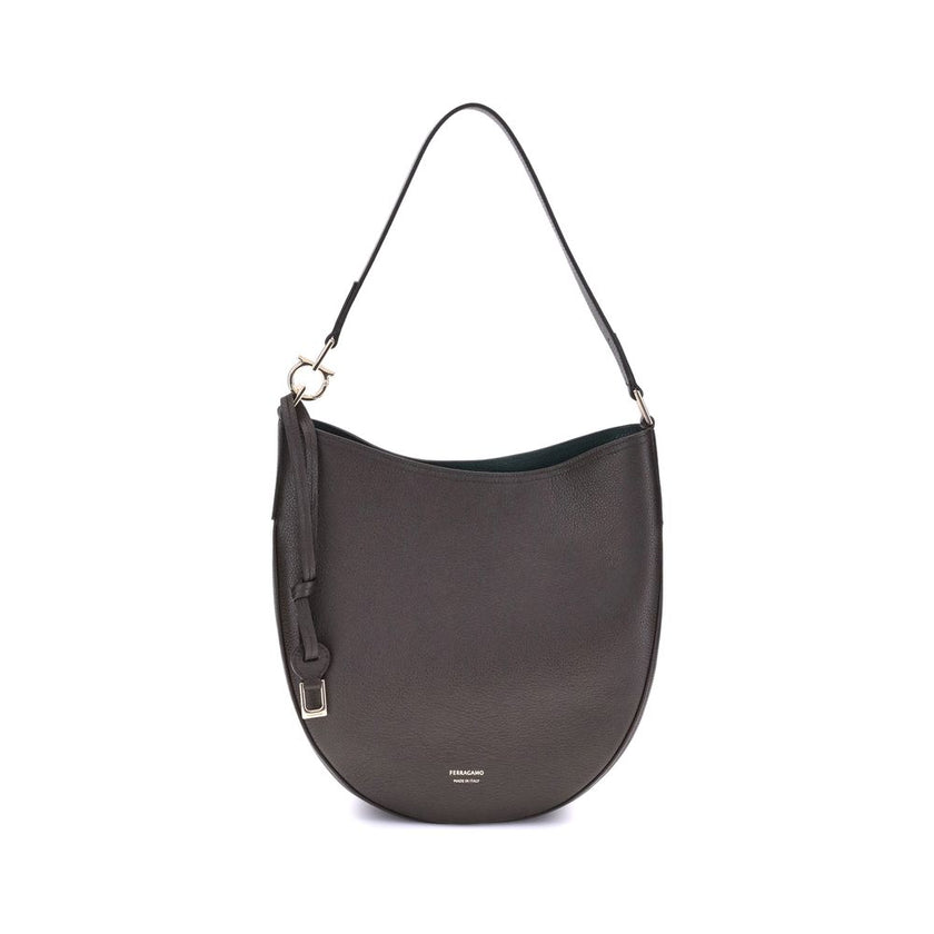 Brown Calf Leather Bos Taurus Shoulder BagFerragamo’s North-South Shoulder Bag, in its medium version, combines elegance and practicality. Made of soft hammered calfskin, it sits harmoniously on the body, ensuring comfort. The opening is secured by a meta