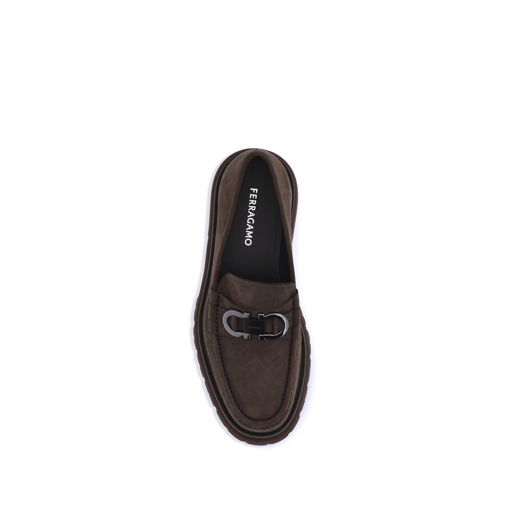 Brown Calf Leather Bos Taurus Slip-On LoafersFerragamo’s Gancini Loafers combine traditional craftsmanship and a contemporary spirit in a sophisticated, bold design. Made of soft suede, they are distinguished by the refined Gancini detail on the front, th
