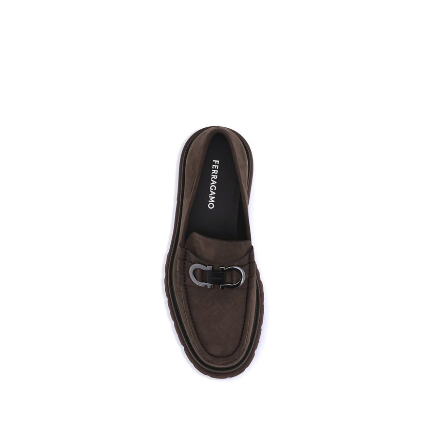 Brown Calf Leather Bos Taurus Slip-On LoafersFerragamo’s Gancini Loafers combine traditional craftsmanship and a contemporary spirit in a sophisticated, bold design. Made of soft suede, they are distinguished by the refined Gancini detail on the front, th