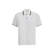 White Cotton Polo ShirtFerragamo’s Cotton Polo Shirt combines elegance with refined details. Featuring a classic collar with contrasting bands, it has a contrasting button closure and a refined embroidered monogram detail on the flap for a distinctive and