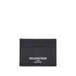 Black Calf Leather Bos Taurus WalletBalenciaga’s Card Holder is made of grained calfskin leather and features a printed logo laminated on the front. Compact and functional, it features a central slit pocket and four credit card slots, combining practicali