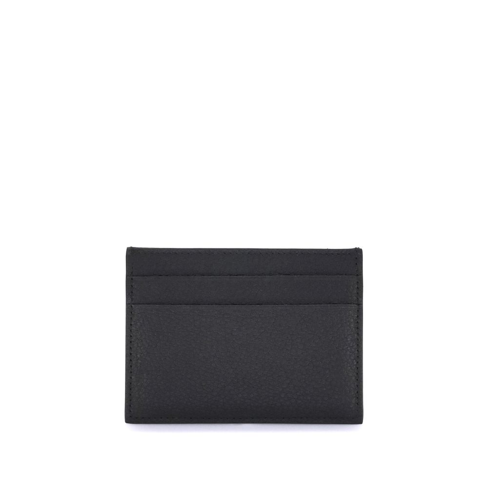 Black Calf Leather Bos Taurus WalletBalenciaga’s Card Holder is made of grained calfskin leather and features a printed logo laminated on the front. Compact and functional, it features a central slit pocket and four credit card slots, combining practicali