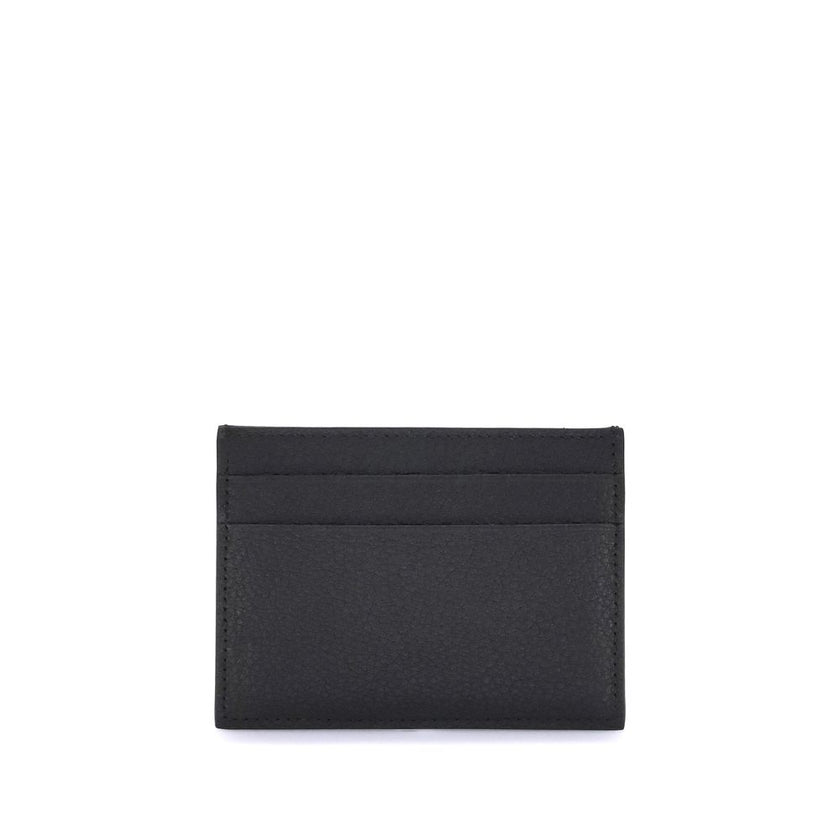 Black Calf Leather Bos Taurus WalletBalenciaga’s Card Holder is made of grained calfskin leather and features a printed logo laminated on the front. Compact and functional, it features a central slit pocket and four credit card slots, combining practicali