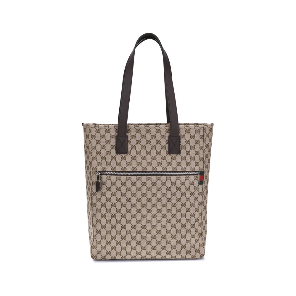 Brown Polyester HandbagGucci’s GG canvas Tote Bag is a timeless classic that combines practicality and iconic luxury. Made of the celebrated GG canvas, it is enhanced by elegant dark brown leather trim that outlines its structure. The distinctive green an