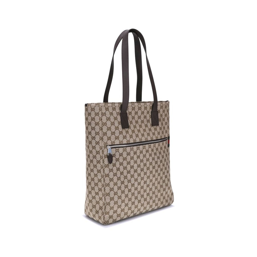 Brown Polyester HandbagGucci’s GG canvas Tote Bag is a timeless classic that combines practicality and iconic luxury. Made of the celebrated GG canvas, it is enhanced by elegant dark brown leather trim that outlines its structure. The distinctive green an