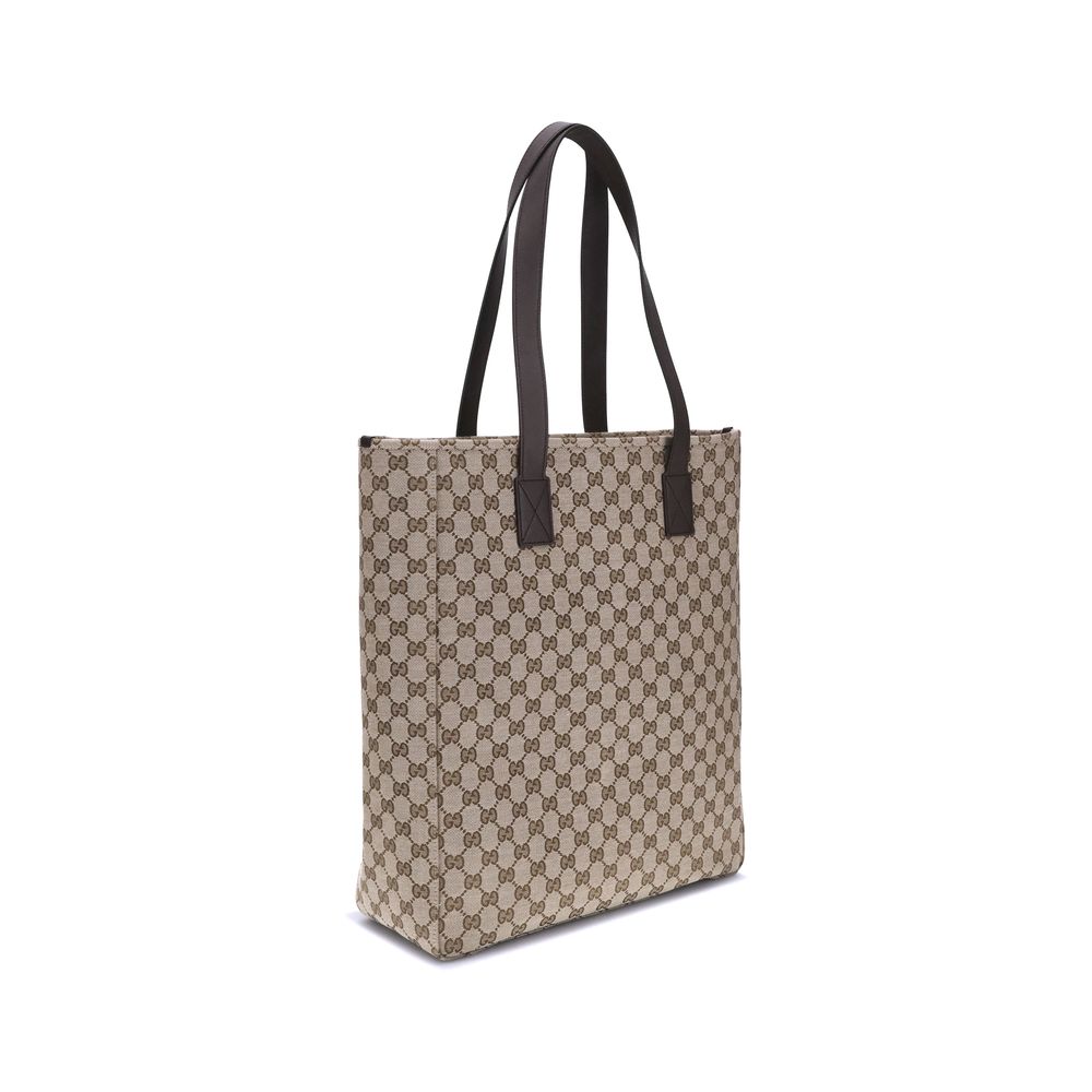 Brown Polyester HandbagGucci’s GG canvas Tote Bag is a timeless classic that combines practicality and iconic luxury. Made of the celebrated GG canvas, it is enhanced by elegant dark brown leather trim that outlines its structure. The distinctive green an