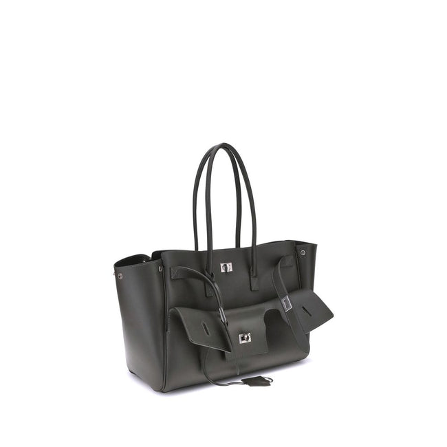Black Calf Leather Bos Taurus Shoulder BagBalenciaga’s Bel Air medium Shoulder Bag is a spacious and functional accessory with a versatile pouch design. It features two handles for convenient carrying and the Balenciaga Paris logo embossed with silver lam
