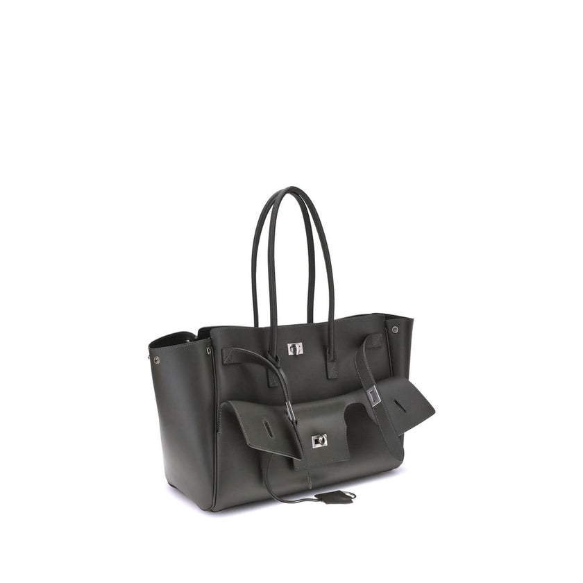 Black Calf Leather Bos Taurus Shoulder BagBalenciaga’s Bel Air medium Shoulder Bag is a spacious and functional accessory with a versatile pouch design. It features two handles for convenient carrying and the Balenciaga Paris logo embossed with silver lam