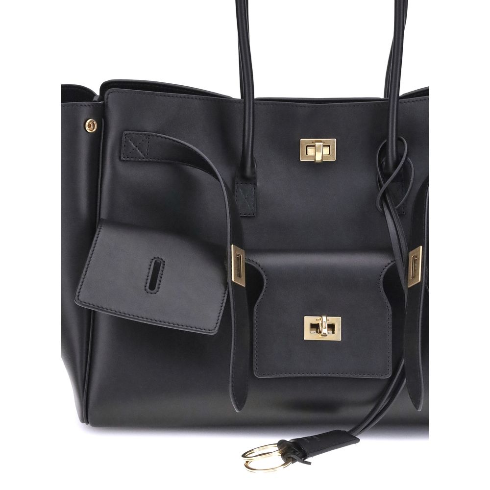 Black Calf Leather Bos Taurus Shoulder BagBalenciaga’s Bel Air medium Shoulder Bag is a spacious and functional accessory with a versatile pouch design. It features two handles for convenient carrying and the Balenciaga Paris logo embossed with silver lam