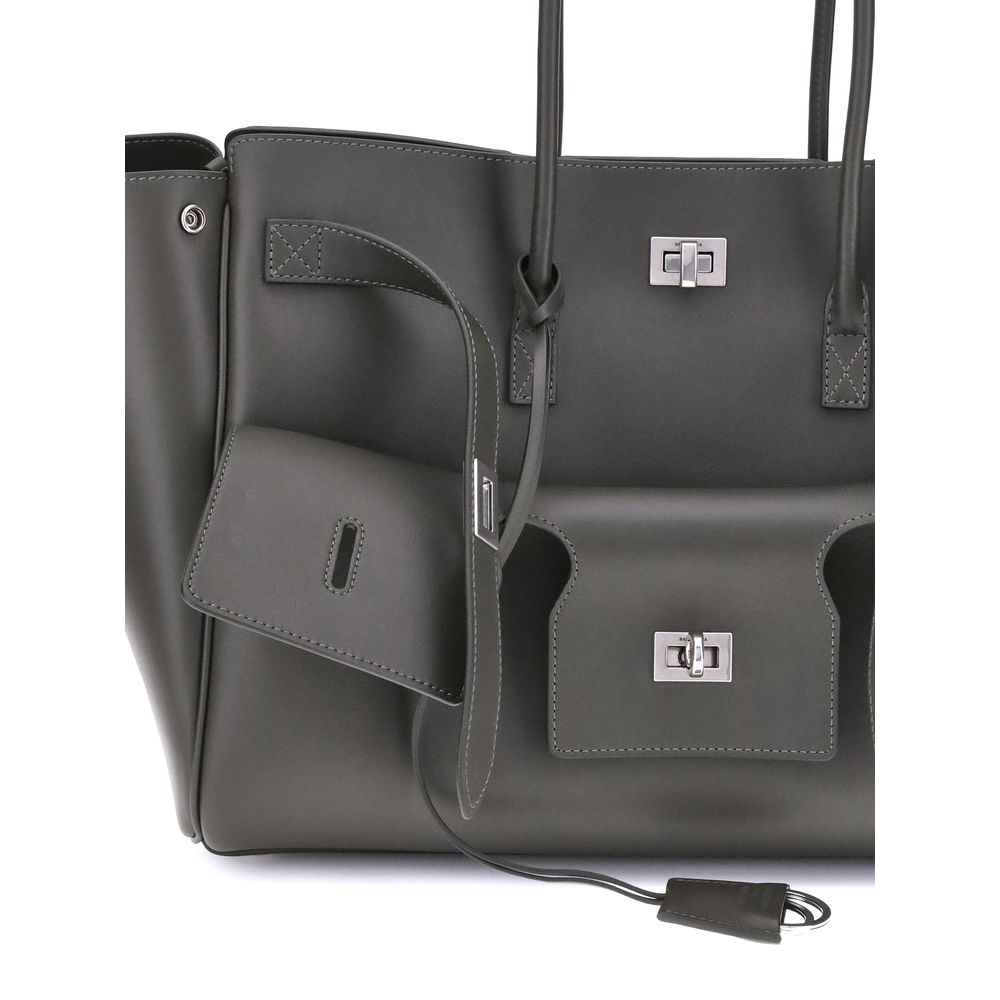 Black Calf Leather Bos Taurus Shoulder BagBalenciaga’s Bel Air medium Shoulder Bag is a spacious and functional accessory with a versatile pouch design. It features two handles for convenient carrying and the Balenciaga Paris logo embossed with silver lam