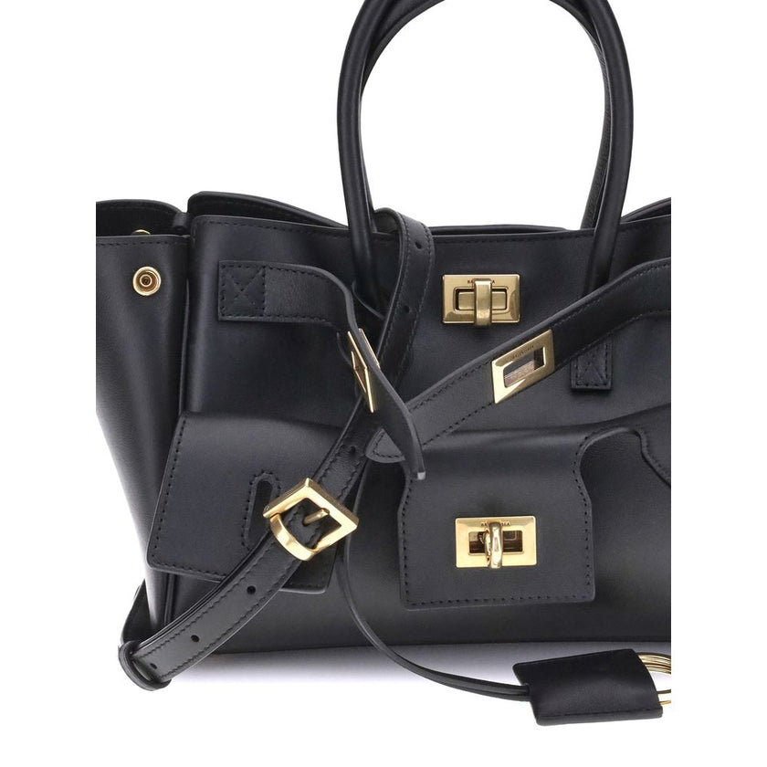 Black Calf Leather Bos Taurus Shoulder BagBalenciaga’s Bel Air mini Handbag is a versatile and iconic accessory. Carried on the shoulder, over the shoulder or by hand, it features two handles and an adjustable, removable shoulder strap. The embossed Balen