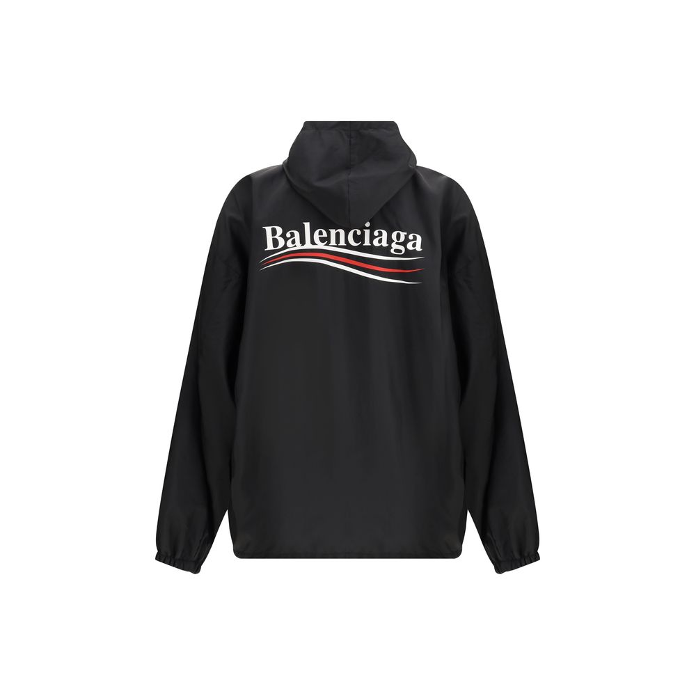 Black Polyester Shell JacketBalenciaga’s Waterproof Jacket is a functional garment with an essential design. Equipped with a hood, it features a front zipper and snap-button closure. The printed logo on the front and back adds an iconic touch, while the t