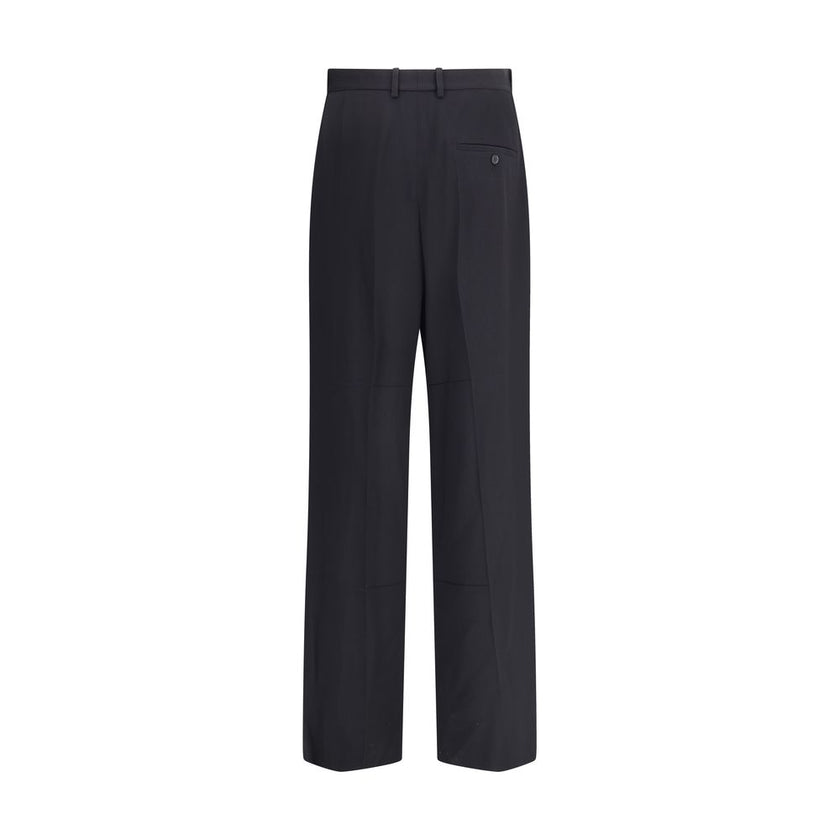 Black Viscose Dress PantsBalenciaga’s tailored Pants feature a zipper and button closure, two side welt pockets and two on the back. Belt loops at the waist complete the garment’s elegant and functional design. Season: AW25 Fit: Regular Composition: 54% V