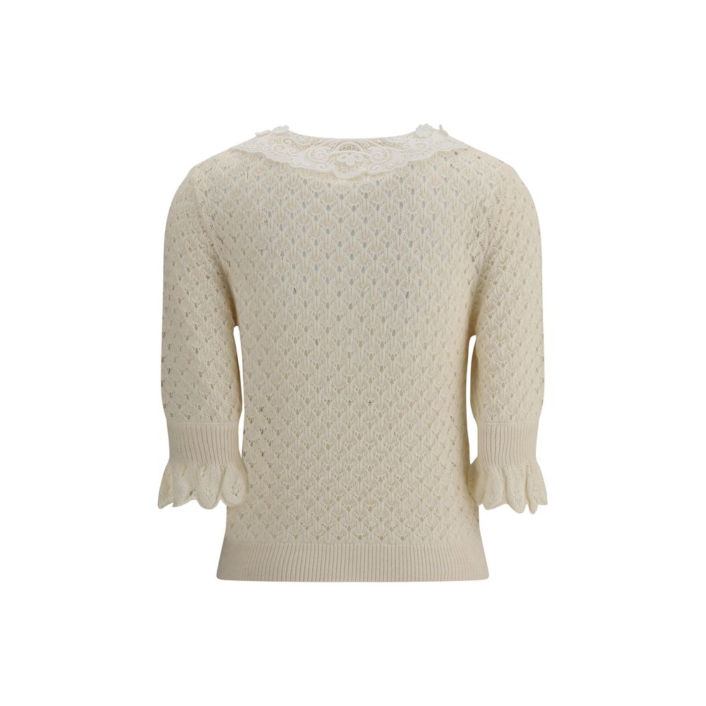 Cream Cotton SweatshirtChloé Sweater is a refined piece that combines delicacy and craftsmanship. It features a distinctive embroidered collar that adds a touch of elegance, and a mid-bust front button closure that defines the style. The openwork knit des