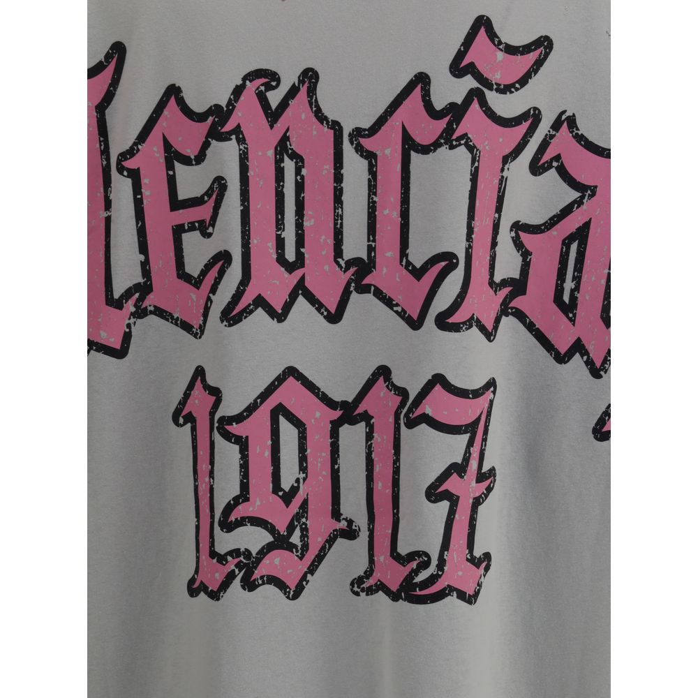 Gray Cotton T-ShirtCotton T-shirt by Balenciaga, featuring a vintage design with a worn effect. The model features a classic ribbed crew neck and an oversized fit that gives a relaxed, contemporary look. On the back, the iconic Balenciaga monogram in cont