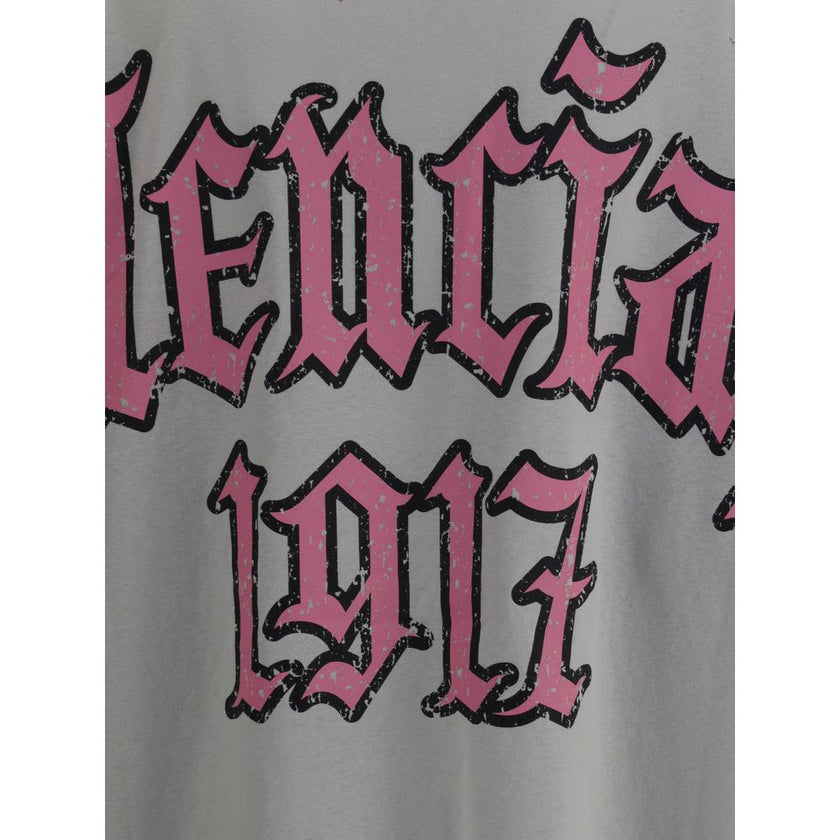 Gray Cotton T-ShirtCotton T-shirt by Balenciaga, featuring a vintage design with a worn effect. The model features a classic ribbed crew neck and an oversized fit that gives a relaxed, contemporary look. On the back, the iconic Balenciaga monogram in cont