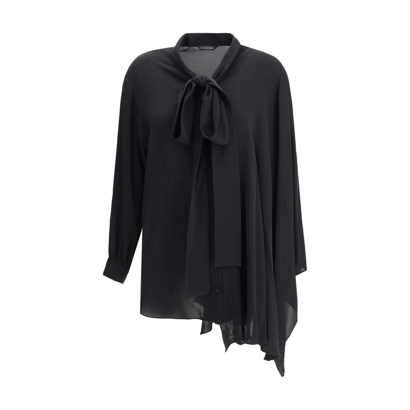 Black Silk BlouseBalenciaga’s asymmetrical Blouse is made of lightweight and fluid pure silk georgette. The sophisticated design is enriched with elegant ribbons to tie at the neck, a batwing sleeve and a long sleeve with a button-adjustable cuff. The fro