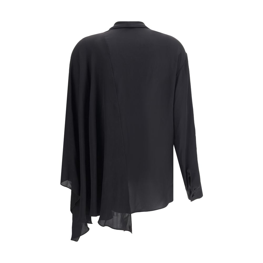 Black Silk BlouseBalenciaga’s asymmetrical Blouse is made of lightweight and fluid pure silk georgette. The sophisticated design is enriched with elegant ribbons to tie at the neck, a batwing sleeve and a long sleeve with a button-adjustable cuff. The fro