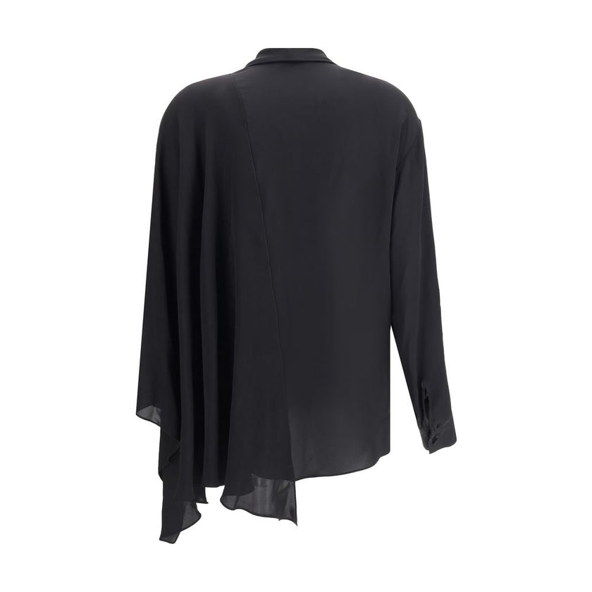 Black Silk BlouseBalenciaga’s asymmetrical Blouse is made of lightweight and fluid pure silk georgette. The sophisticated design is enriched with elegant ribbons to tie at the neck, a batwing sleeve and a long sleeve with a button-adjustable cuff. The fro