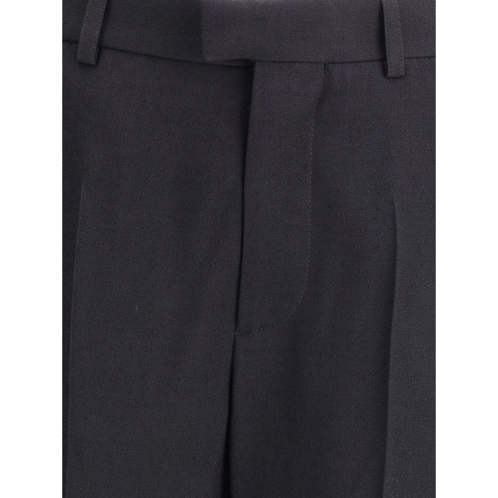 Black Viscose Flared PantsBalenciaga’s flare Pants have a sleek and contemporary cut. The model features a zipper and button closure, belt loops at the waist and two side slash pockets. The flared silhouette enhances the figure, making the garment ideal f