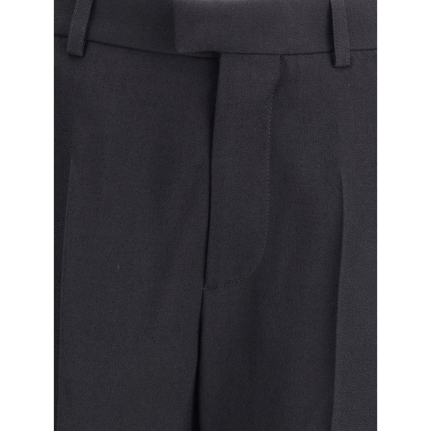 Black Viscose Flared PantsBalenciaga’s flare Pants have a sleek and contemporary cut. The model features a zipper and button closure, belt loops at the waist and two side slash pockets. The flared silhouette enhances the figure, making the garment ideal f