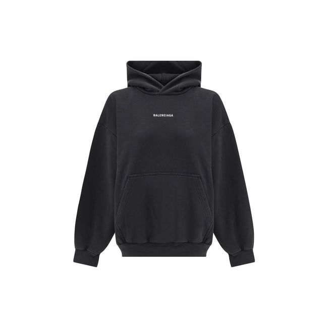 Black Cotton SweatshirtBalenciaga’s monogram hoodie made from soft cotton, this sweatshirt combines comfort with distinctive style. The design is complemented by a patch kangaroo pocket on the front, ribbed cuffs and hem for a structured fit. The iconic c