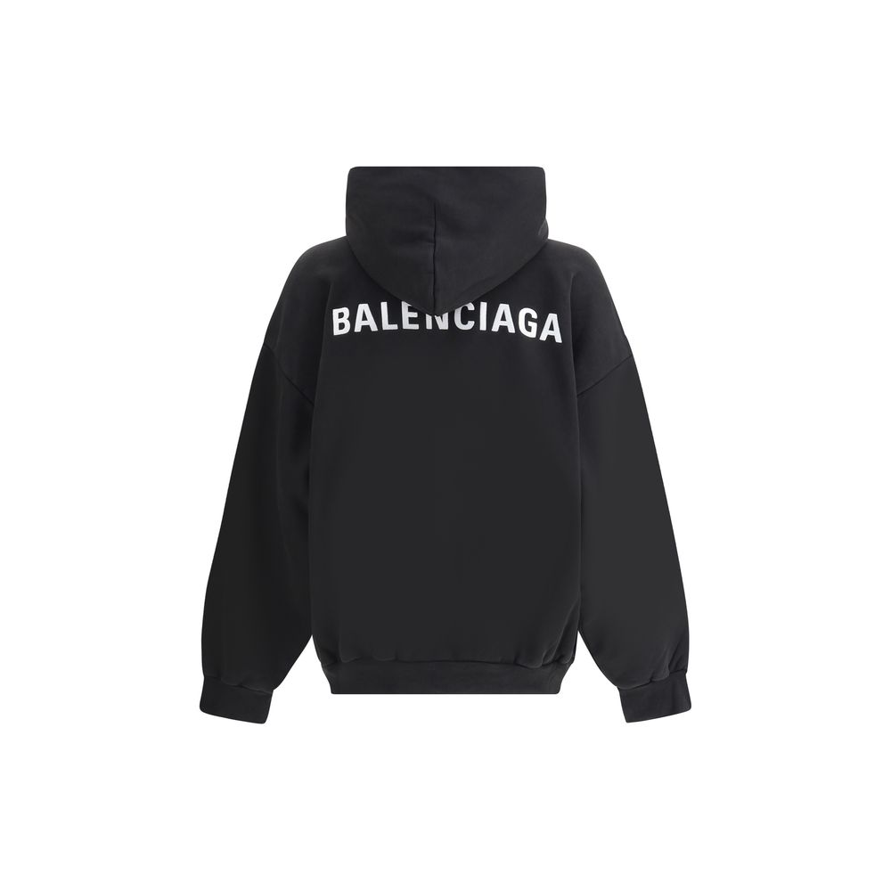 Black Cotton SweatshirtBalenciaga’s monogram hoodie made from soft cotton, this sweatshirt combines comfort with distinctive style. The design is complemented by a patch kangaroo pocket on the front, ribbed cuffs and hem for a structured fit. The iconic c
