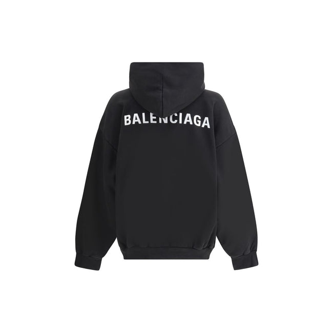 Black Cotton SweatshirtBalenciaga’s monogram hoodie made from soft cotton, this sweatshirt combines comfort with distinctive style. The design is complemented by a patch kangaroo pocket on the front, ribbed cuffs and hem for a structured fit. The iconic c