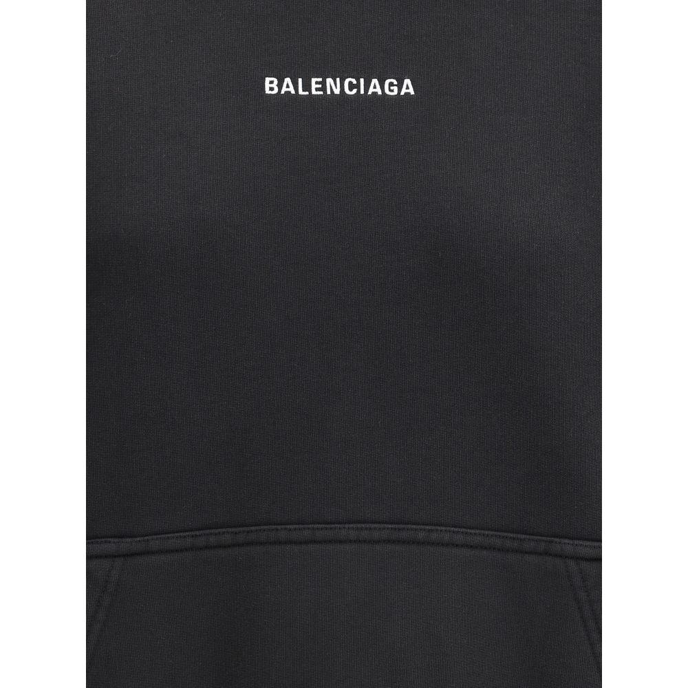 Black Cotton SweatshirtBalenciaga’s monogram hoodie made from soft cotton, this sweatshirt combines comfort with distinctive style. The design is complemented by a patch kangaroo pocket on the front, ribbed cuffs and hem for a structured fit. The iconic c