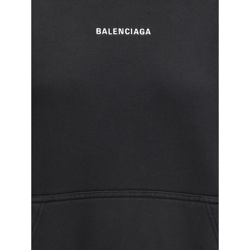 Black Cotton SweatshirtBalenciaga’s monogram hoodie made from soft cotton, this sweatshirt combines comfort with distinctive style. The design is complemented by a patch kangaroo pocket on the front, ribbed cuffs and hem for a structured fit. The iconic c